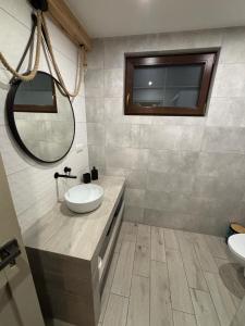 a bathroom with two sinks and a mirror at Skrzynia in Skrzynia