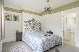 a bedroom with a bed and a sink at 19th Century House Private Parking nr Painswick in Painswick