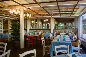 a dining room with blue tables and chairs at Cesenatico Camping Village in Cesenatico