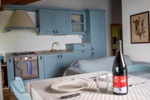 a kitchen with a table with a bottle of wine at Casa Caravino in Varenna