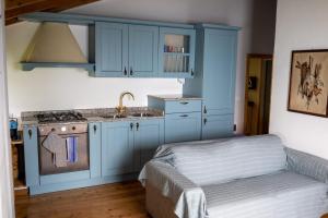 a kitchen with blue cabinets and a sink at Casa Caravino in Varenna