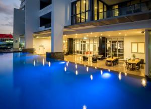 a swimming pool in the middle of a house at Synergy Broadbeach - Official in Gold Coast