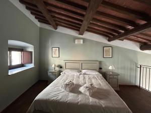 a bedroom with a large bed with two night stands at Palazzo Contelori in Terni