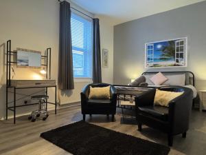 a living room with a couch and a desk at Jacksons Modern Retreat Close to Tynemouth in Tynemouth +44 photos