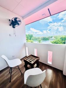a room with a table and two chairs and a large window at Alnaro Hotel & Resort in Moratuwa