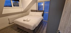 a bedroom with a bed with two shoes on it at SAV Stays Apartments Nottingham Road Loughborough in Loughborough +15 photos