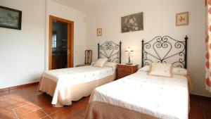 En eller flere senge i et værelse på Villa La Palma