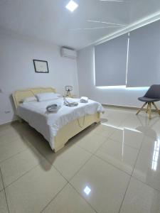 a bedroom with a bed and a large window at Lindo y Moderno Departamento, Parqueo in SamborondÃ³n +46 photos