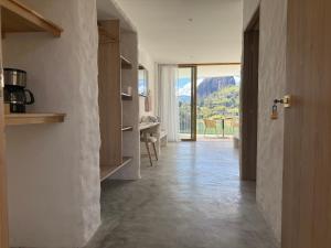 a kitchen with a hallway with a view of a mountain at MYLOS Hotel Boutique in Guatapé