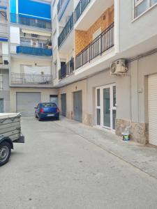 a car parked in a parking lot next to a building at Apartment Azul in Santa Pola