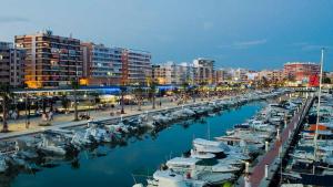 a marina with boats in the water and buildings at Apartment Azul in Santa Pola