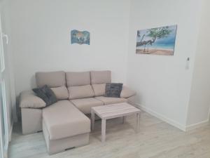 a living room with a couch and a table at Apartment Azul in Santa Pola