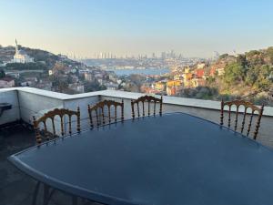a table and chairs on a balcony with a view at Heavenly Peace Stunning View Terrace Jacuzzi in Istanbul