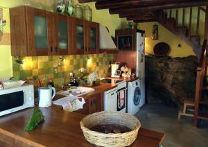 a kitchen with a counter and a sink and a microwave at Maison Kyriakou in Stavrinídes