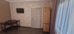 Zimmer mit einem Tisch, einem Stuhl und einer Tür in der Unterkunft Стаи за гости Георги Сава Раковски 97 in Targowischte + 2 Fotos
