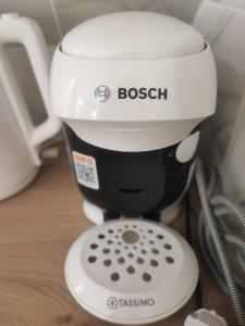 a coffee maker sitting on a table next to a phone at La Green Room in Poitiers