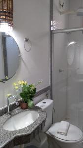 a bathroom with a toilet and a sink and a shower at Pousada Eucaliptos in Barra Grande +78 photos