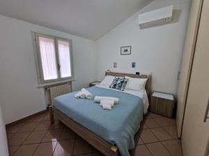 Postel nebo postele na pokoji v ubytování La Casetta del Borgo