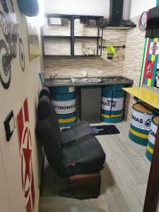 a car garage with a chair and a table at Gigiotto garage in Siracusa +9 photos