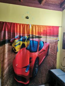 two cars are parked in a room with a curtain at Gigiotto garage in Siracusa