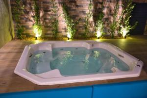 a jacuzzi tub in a room with lights at Life Residence in Belo Horizonte