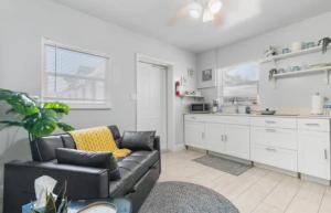 a living room with a couch and a kitchen at Cozy Casarita Cottage in Miami +9 photos
