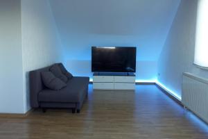 a living room with a couch and a television at Zentral Wohnen Am Querweg! in Paderborn