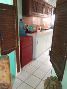 a kitchen with a red cabinet and a sink at Habitación con clima in Manzanillo