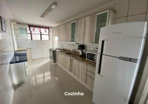 a kitchen with a white refrigerator in a room at Apartamento no Centro de Bento Gonçalves in Bento Gonçalves +10 photos