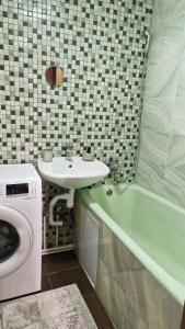 a bathroom with a sink and a washing machine at Air-Moldova 25 in Chişinău