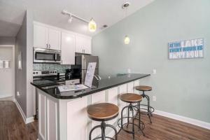 a kitchen with a counter with stools and a counter top at Beachside 325 Waterfront Condo in Traverse City