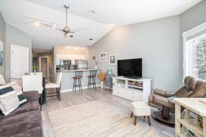 a living room with a couch and a tv at Beachside 323 Waterfront Condo in Traverse City
