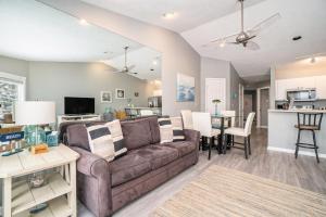 a living room with a couch and a dining room at Beachside 323 Waterfront Condo in Traverse City