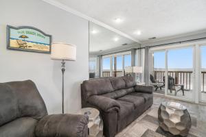 a living room with a couch and a chair at Beachside 218 Luxury Condo on the Beach in Traverse City