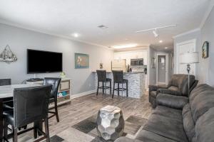 a living room with a couch and a table at Beachside 218 Luxury Condo on the Beach in Traverse City