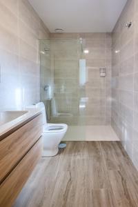 a bathroom with a toilet and a sink and a shower at Casa Melina in Villapedre