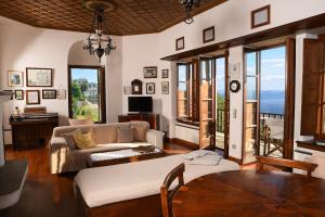 a living room with a couch and a table at Milies Historic Chalet Pelion in Mileai