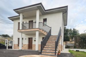 a house with a staircase in front of it at Casa Melina in Villapedre