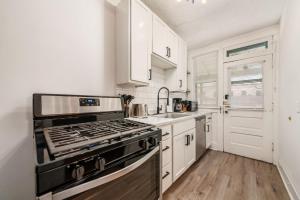 a kitchen with a stove and a sink at The Cobblestone Townhouse - 2 BR -German Village in Columbus +20 photos