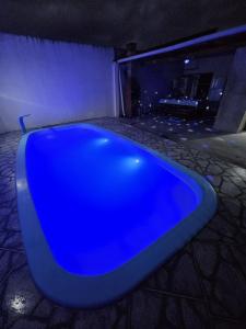 a blue bath tub sitting in a room at Casa aconchego com piscina in Guaratuba