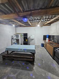 a room with a bed in the middle of a kitchen at Casa aconchego com piscina in Guaratuba