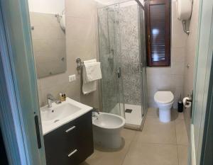 a bathroom with a sink and a shower and a toilet at Villette Oasi in San Teodoro +52 photos