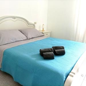 a bedroom with a bed with two towels on it at Villa Annette #Vivere la Puglia in Villa Castelli