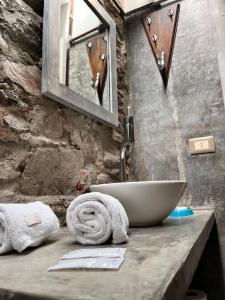 a bathroom with a sink and a mirror on a counter at La Nueva Posadita in Colonia del Sacramento