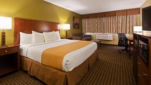 a hotel room with a large bed and a desk at Best Western Executive Inn Kenosha - Pleasant Prairie in Kenosha +16 photos