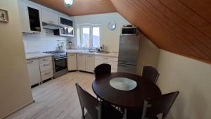 a kitchen with a table and chairs in a room at Dom Na Kraju in Łomnica Zdrój