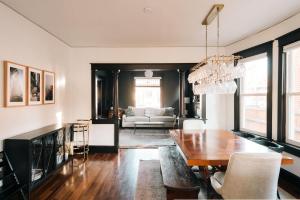 a living room with a table and a couch at Exquisite Craftsman - RiNo&Cole - Backyard Garden in Denver
