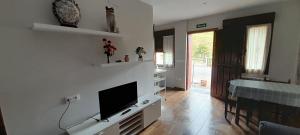 a living room with a flat screen tv on a wall at Apartamentos Miravalles B in Villaviciosa