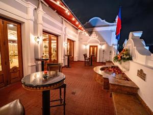 a lobby with two tables and a flag on the wall at Plaza Grande Hotel in Quito