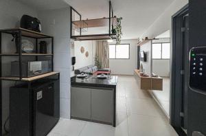 a kitchen with a black counter top in a room at Flat Super Aconchegante Intermares 4 Pessoas in Cabedelo +7 photos